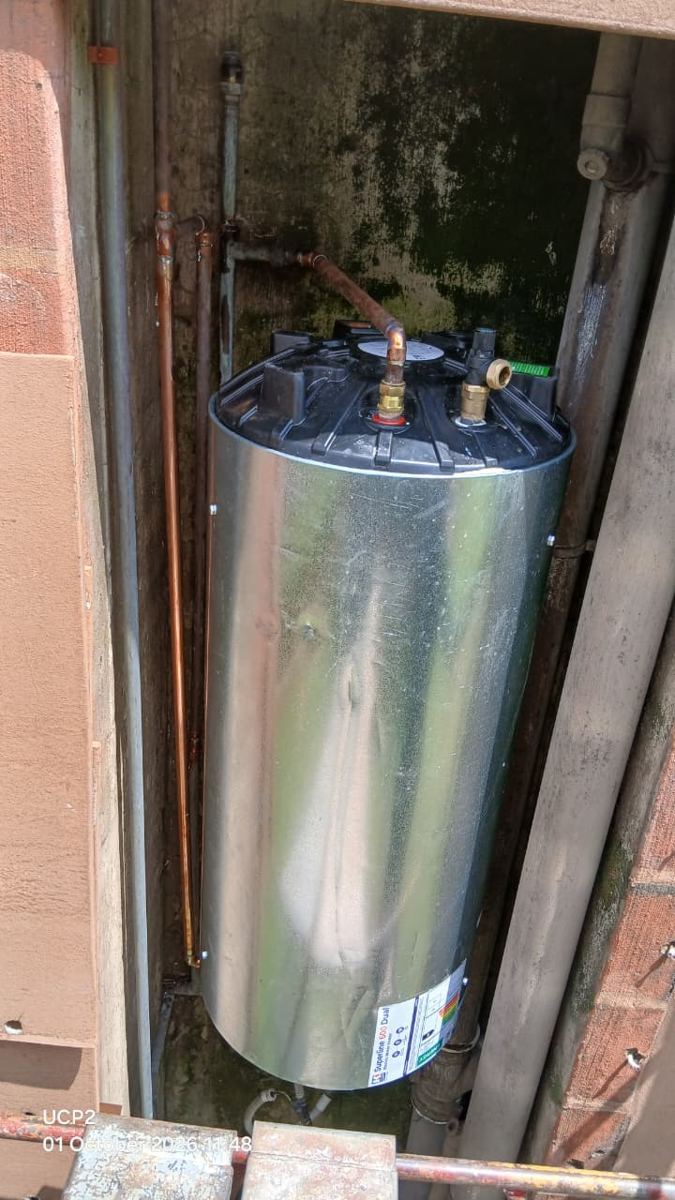 Replacement vertical geyser fitted in a complex's plumbing duct
